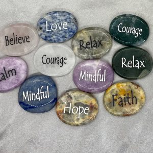 Engraved worry stones of various color and engraved word